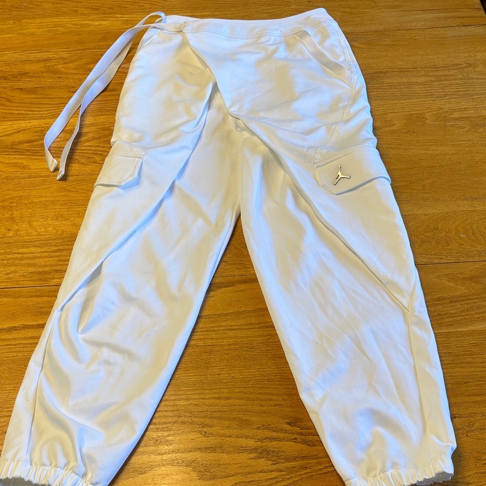 Jordan  White Cargo Pants with pockets and ties on the hip.